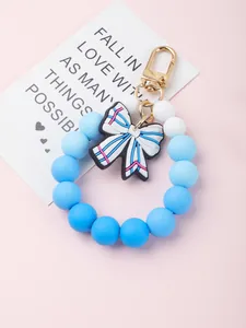 Close-up of food-grade silicone beaded keychain bracelet with a cute striped bow pendant