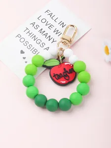 Teacher gift silicone beaded keychain bracelet with apple charm on pink background