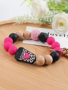 Macro view of silicone bead wristlet keychain with leopard heart coffee cup charm detail