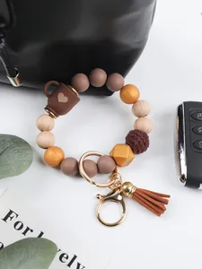 Macro detail view of silicone bead keychain with wooden beads and coffee cup charm