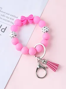 Stijlvolle roze siliconen kralen sleutelhanger armband met strik en PU-kwastje