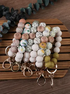 Detailed view of assorted silicone beaded wristlets with floral prints and metal clips
