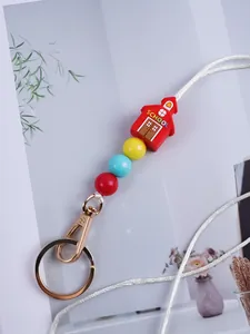Detailed view of DIY silicone bead keychain featuring a red schoolhouse and colorful beads