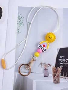 Macro view of handmade silicone beaded lanyard with sun and teacher rainbow charms