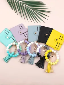 Assorted colorful silicone beaded wristlets with matching PU leather card holder wallets