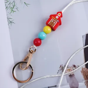 Colorful silicone beaded keychain with a red schoolhouse charm for bag decoration