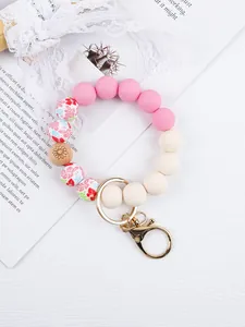 Close-up detail of floral print and silicone beads on a boho wristlet keychain with gold clasp