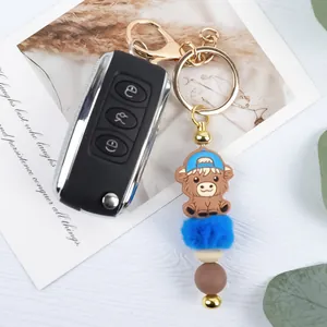 Cute cartoon highland cow keychain with blue pom-pom and silicone beads bag charm