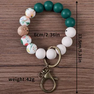 Silicone beaded wristlet keychain with floral printed beads and bronze metal clasp