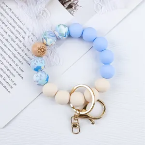 Boho style floral and solid blue silicone beaded wristlet keychain with gold keyring