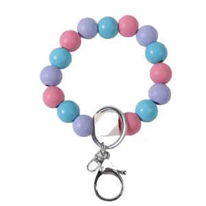 Macaron colored wooden bead bracelet keychain featuring pink blue and purple round beads