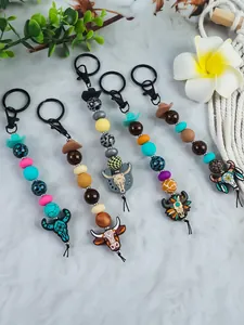 Detailed macro view showing a collection of western cowboy bull head beaded keychains