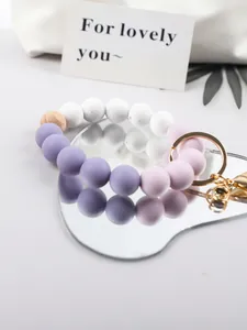 Close-up of candy-colored silicone beaded keychain with a natural wood accent