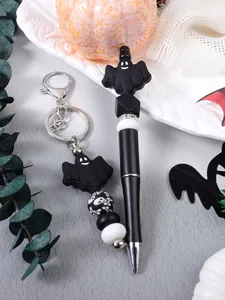 Close-up detail of Halloween ghost silicone beaded pen and matching keychain accessory set