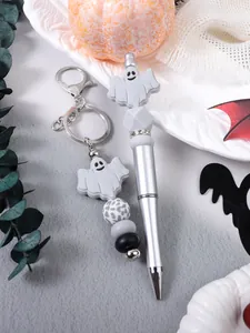 Close-up of Halloween ghost silicone beaded keychain and matching silver beaded pen set