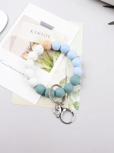 Macro detail of candy-colored silicone beads and natural wood bead keychain accessory