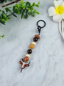 Close-up of Western cowboy style bull head beaded keychain with brown hat charm
