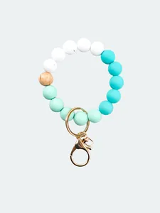 Close-up detail of candy-colored silicone beads with a golden lobster clasp and wooden bead