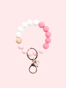 Silicone beaded keychain wristlet in pink and white candy colors with rose gold hardware