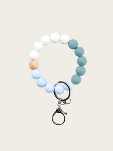 Close-up of silicone bead keychain with wooden bead and silver metal lobster clasp