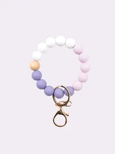 Detailed view of candy-colored silicone beads and gold-tone lobster clasp for DIY bag charms.