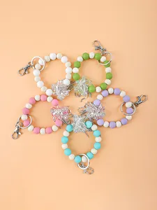 Bunte Schlüsselanhänger aus Silikonperlen mit funkelnden Strass-Blumenanhängern
