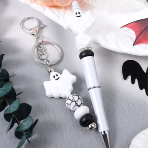 Halloween ghost silicone beaded keychain and beaded pen set on a festive themed background