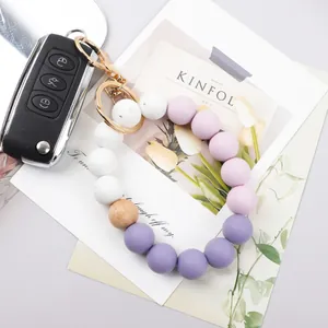 Pastel silicone beaded wristlet keychain shown in an elegant lifestyle flat lay setting.