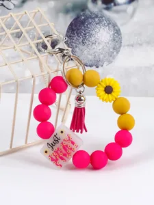 Detail view of colorful silicone bead keychain with Just PRAY charm and tassel