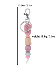Close-up detail of floral rose silicone bead keychain with size and weight specs