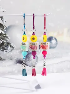 Detailed view of sunflower silicone bead keychains with Just PRAY print and tassels