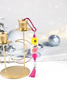 Detailed view of colorful sunflower keychain with Just Pray bead and pink tassel