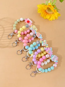 Set of six colorful silicone bead keychains featuring various cute cartoon charms
