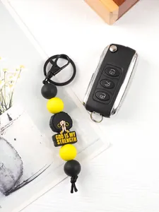 Close-up view of the silicone bead keychain with God Is My Strength charm and car key