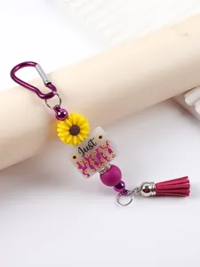 Detail of silicone bead keychain featuring Just PRAY text and a purple tassel charm