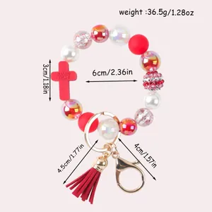 Silicone beaded keychain bracelet with red cross and tassel, including dimensions