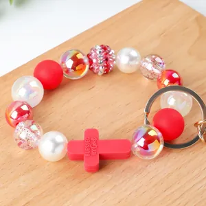 Handmade silicone beaded keychain bracelet with red 'Blessed by God' cross charm