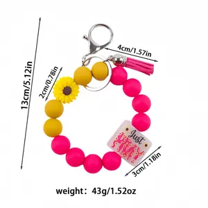 Silicone bead wristlet keychain with sunflower charm and tassel, measuring 5.12 inches.