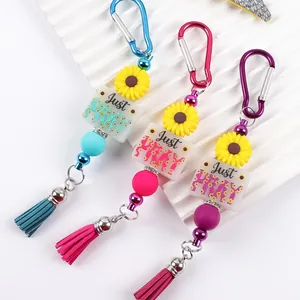 Vibrant silicone bead keychain featuring sunflower charm and Just Pray tassel pendant