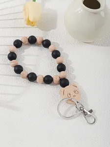Close-up of silicone and wooden beaded keychain with laser-engraved panda charm
