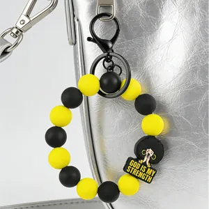 Yellow and black silicone bead keychain with God Is My Strength charm for handbag.