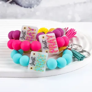 Colorful silicone bead wristlet keychain with daisy Just Pray charm and tassel charm