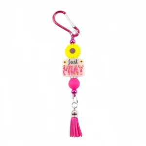 Vibrant silicone bead keychain featuring a sunflower charm, Just PRAY bead and pink tassel.