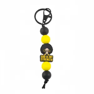 Yellow and black silicone bead keychain with 'God Is My Strength' prayer charm