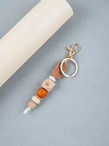 Detailed view of handmade keychain with rose silicone and butterfly wooden beads