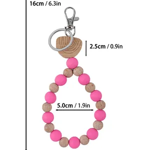 Handmade pink silicone and wooden beaded keychain wristlet with detailed size specifications