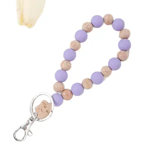 Lavender purple silicone and natural wood beaded wristlet keychain with smiley face charm