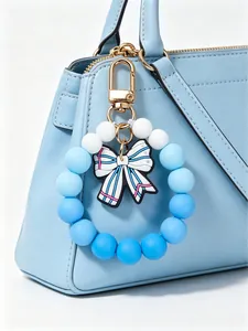 Detailed view of a blue and white silicone beaded keychain with a cute bow charm