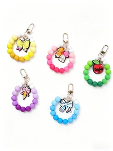 Close-up of five colorful silicone beaded wristlet keychains with teacher charms