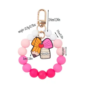 Silicone beaded keychain bracelet with pink gradient beads and school charms